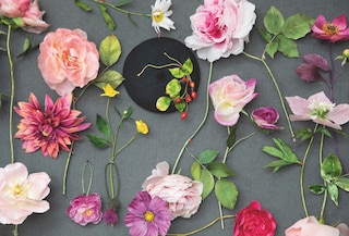 Handmade roses, cosmos, buttercups and dahlias along with sprays of red rose hips