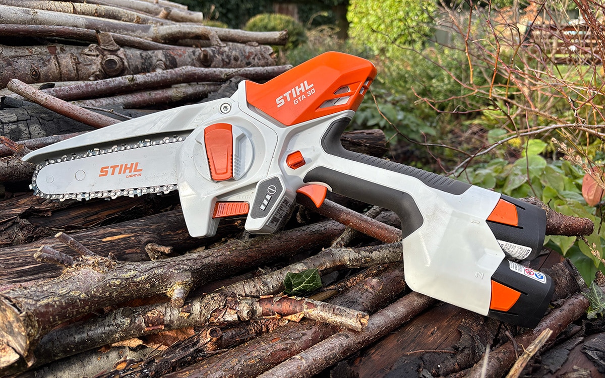 The STIHL GTA 30 cordless pruner on a log pile