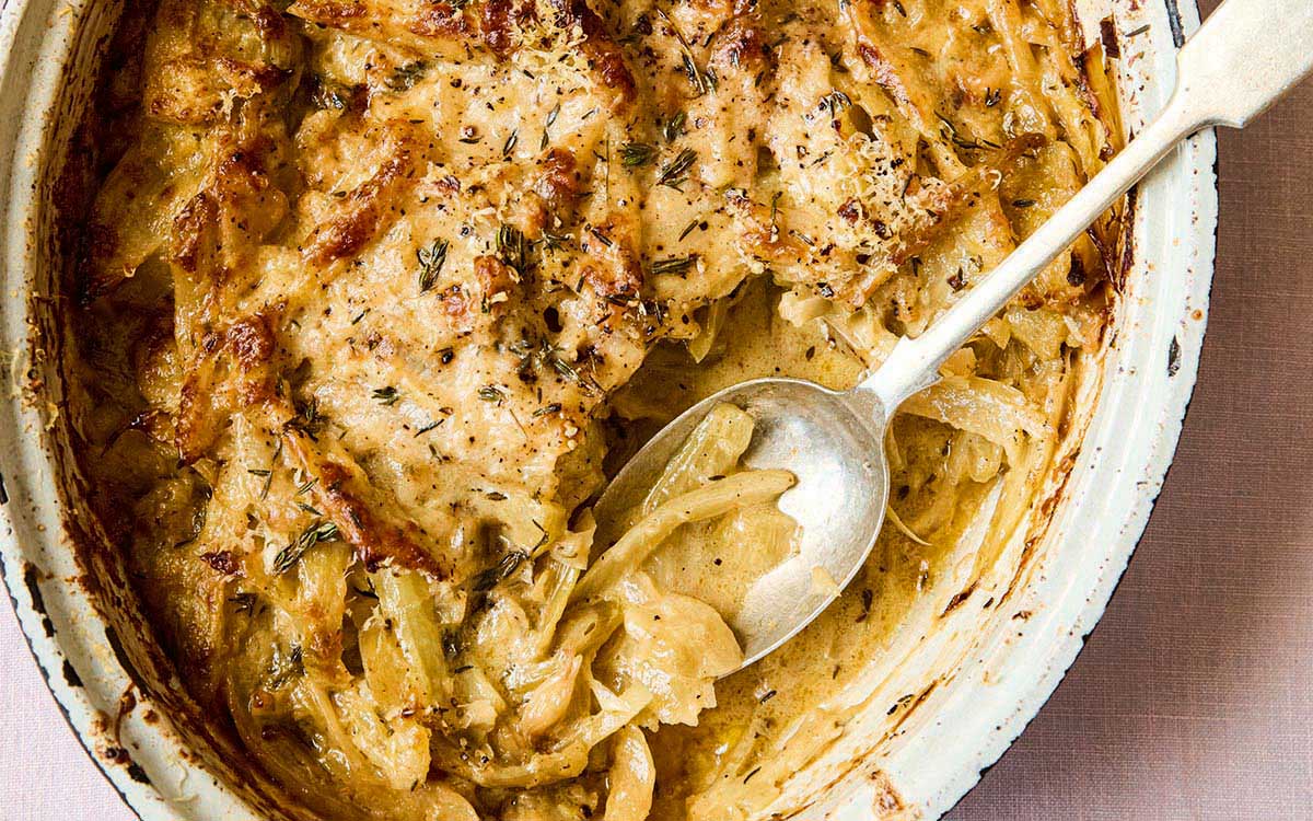 Fennel in a rustic gratin dish cooked with onions, creme fraiche and nutmeg