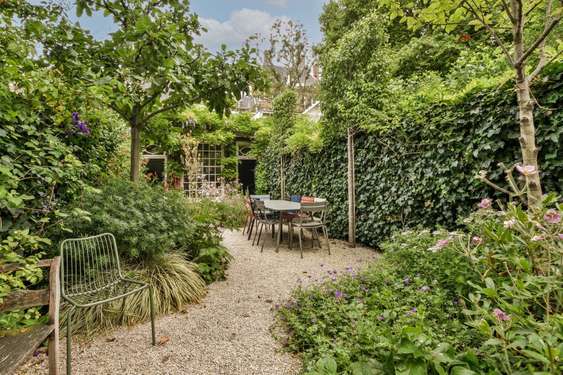 Simple small patio with small garden near wooden fence