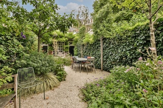 Simple small patio with small garden near wooden fence