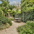 Simple small patio with small garden near wooden fence