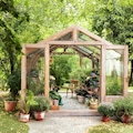 Interior of a wooden illuminated greenhouse with furniture