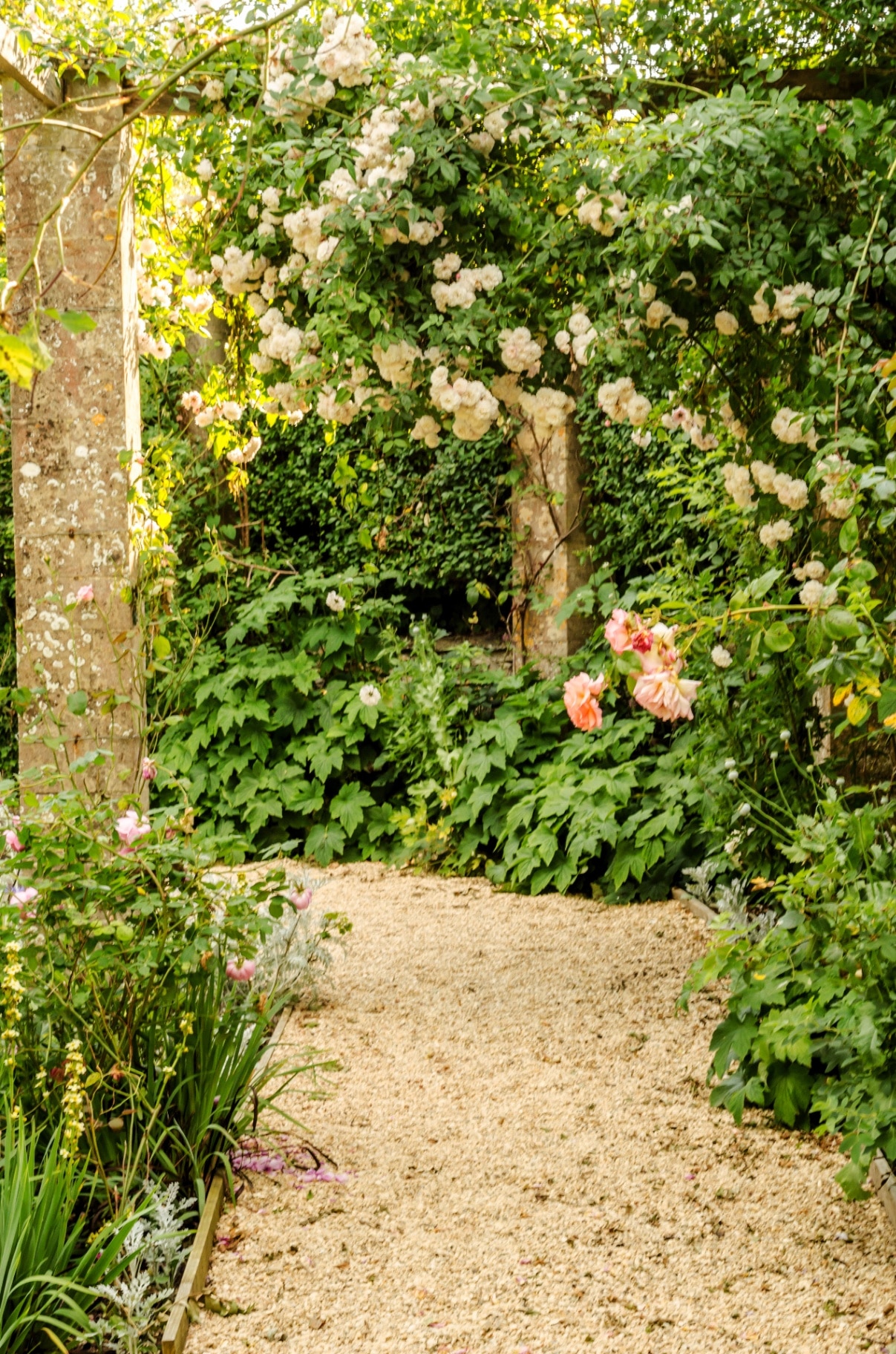Beautiful park in antique style, stone decorations on pedestals, beautiful plants, resting place