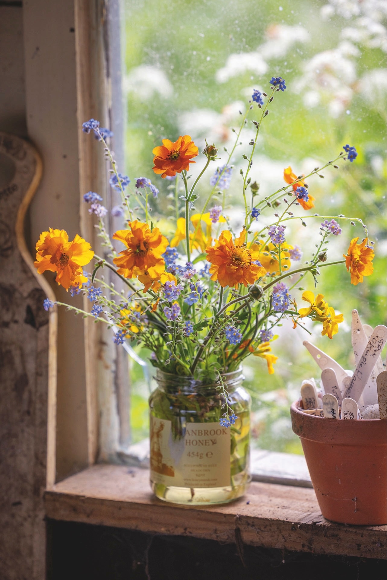 A pretty posy of geums plucked from the garden with contrasting sprigs of forget-me-nots.