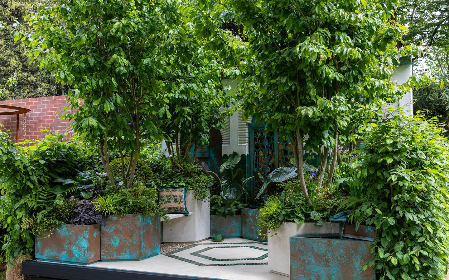 Turquoise and verdigris container garden with Persian motifs and water. 