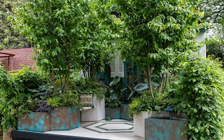 Turquoise and verdigris container garden with Persian motifs and water.