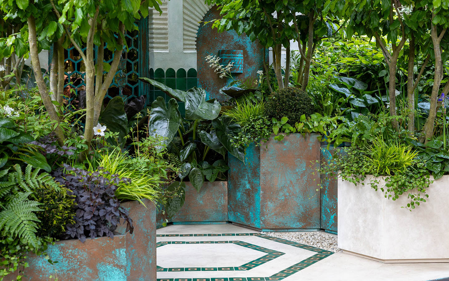 A small garden with many lush plants and a repeated octagonal motif throughout.