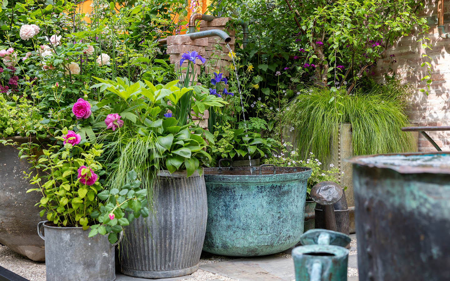 Old dolly tubs and washing coppers with a copper water spout.