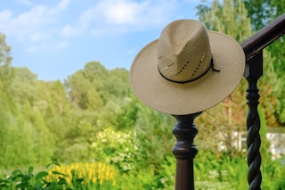 Straw Hat hanging in the green garden