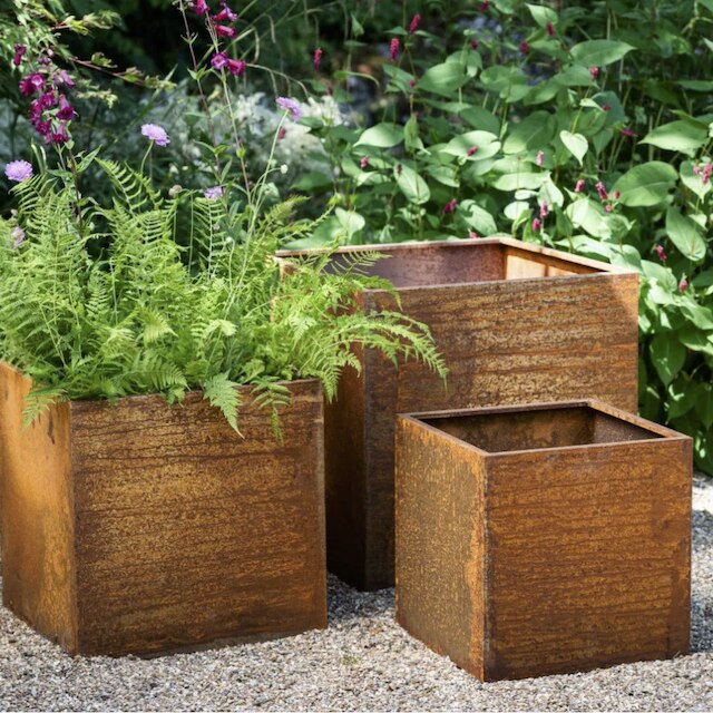 A trio of corten steel planters 